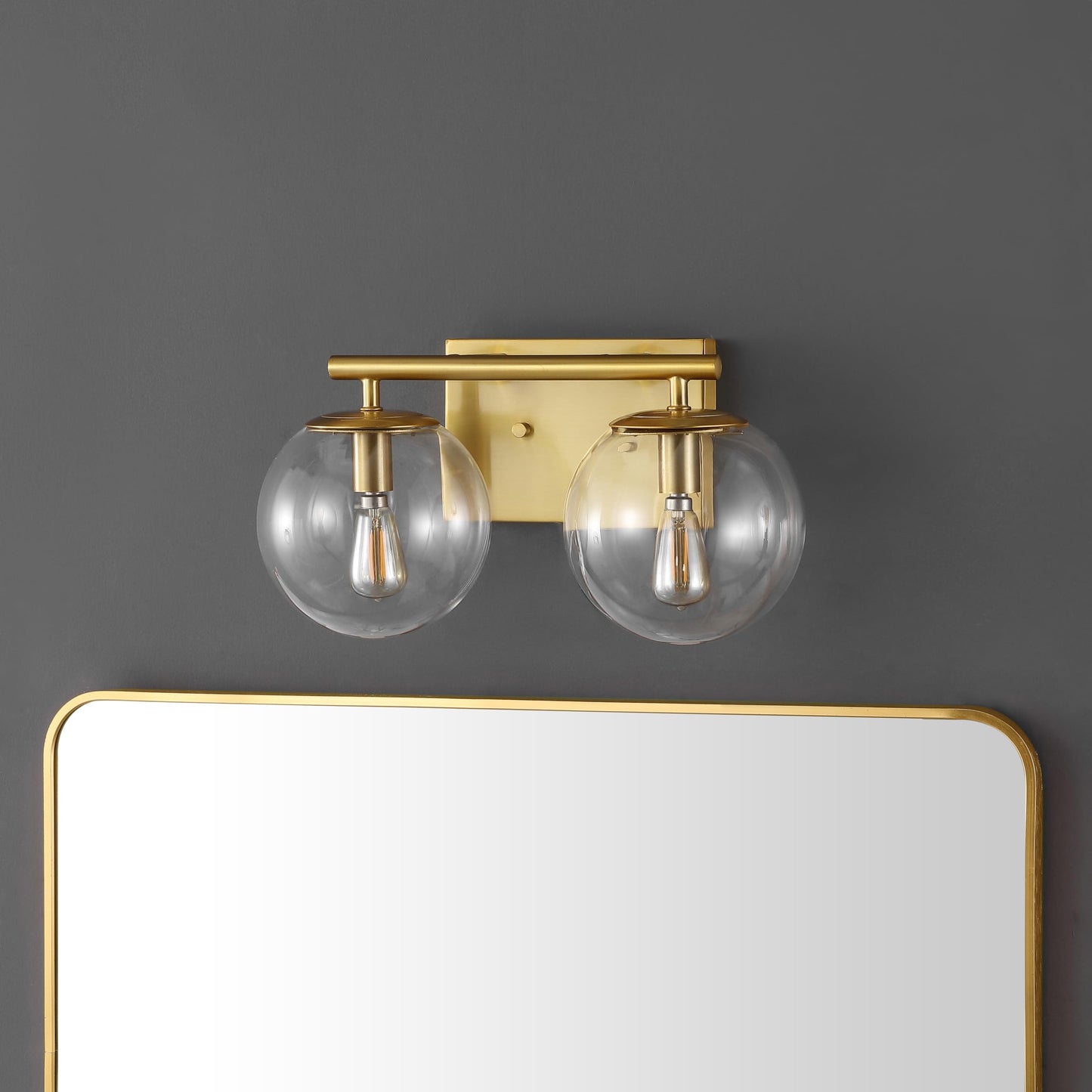 SAFAVIEH Lighting Collection Severa Brass/Clear Glass Globe Shade 2-Light Wall Sconce Light Fixture, Ideal for Bathroom, Entryway, Vanity, Foyer